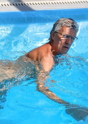 Gay grandpa gives a handsome twink a blowjob and rimjob at the pool