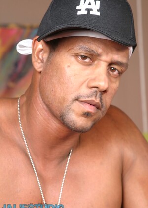 Hot gay ebony Aron Ridge unveils his muscular body and big black dick