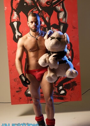 Sexy gay bodybuilder Manuel Roko poses in a hot setting with chains