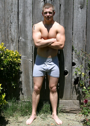 Muscular gay studs Tommy D & Hoyce flaunting their mighty chests outdoors
