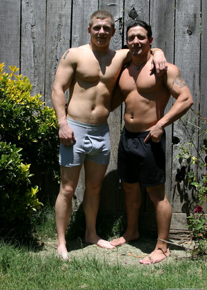 Muscular gay studs Tommy D & Hoyce flaunting their mighty chests outdoors