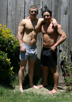 Muscular gay studs Tommy D & Hoyce flaunting their mighty chests outdoors