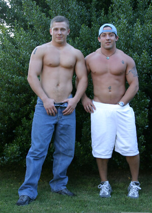Muscular gay studs Tommy D & Hoyce flaunting their mighty chests outdoors