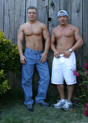 Muscular gay studs Tommy D & Hoyce flaunting their mighty chests outdoors