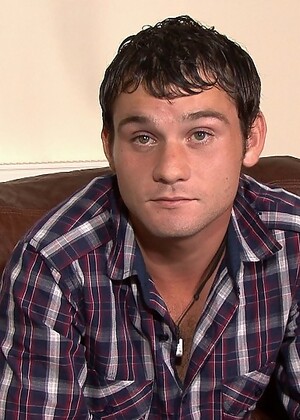 Owen wastes no time in getting his thick uncut rod to full mast and kneels up on the couch to give his cock a slow
