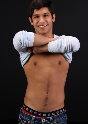Carmine posing naked in a bedroom