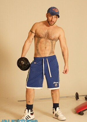 Strong hairy gay athlete Aitor Crash strips naked while lifting weights